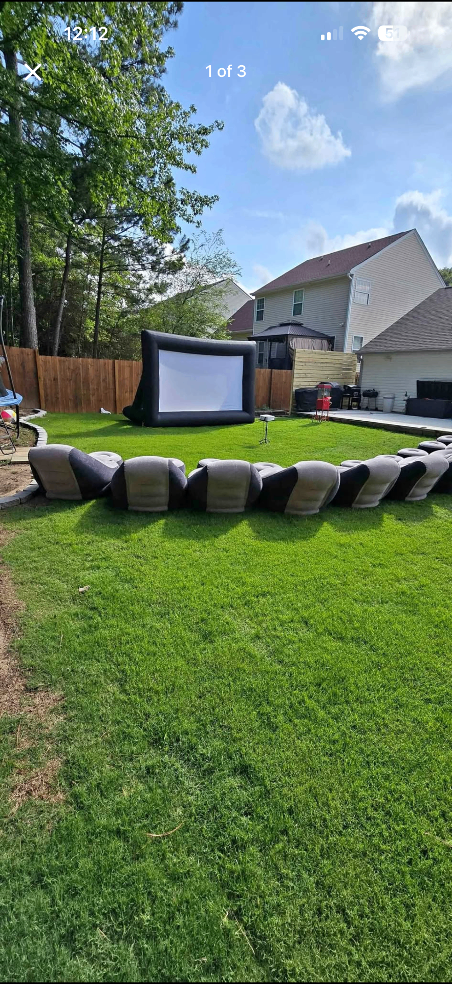 Backyard movie night setup with inflatable screen and inflatable seating